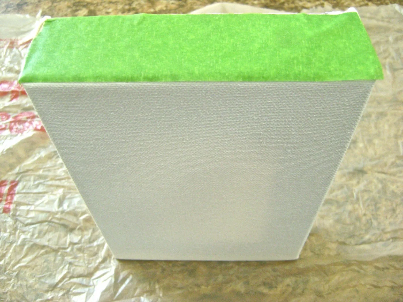 step 4 - Place masking tape across the top canvas panel to protect it from adhesive in the next step.