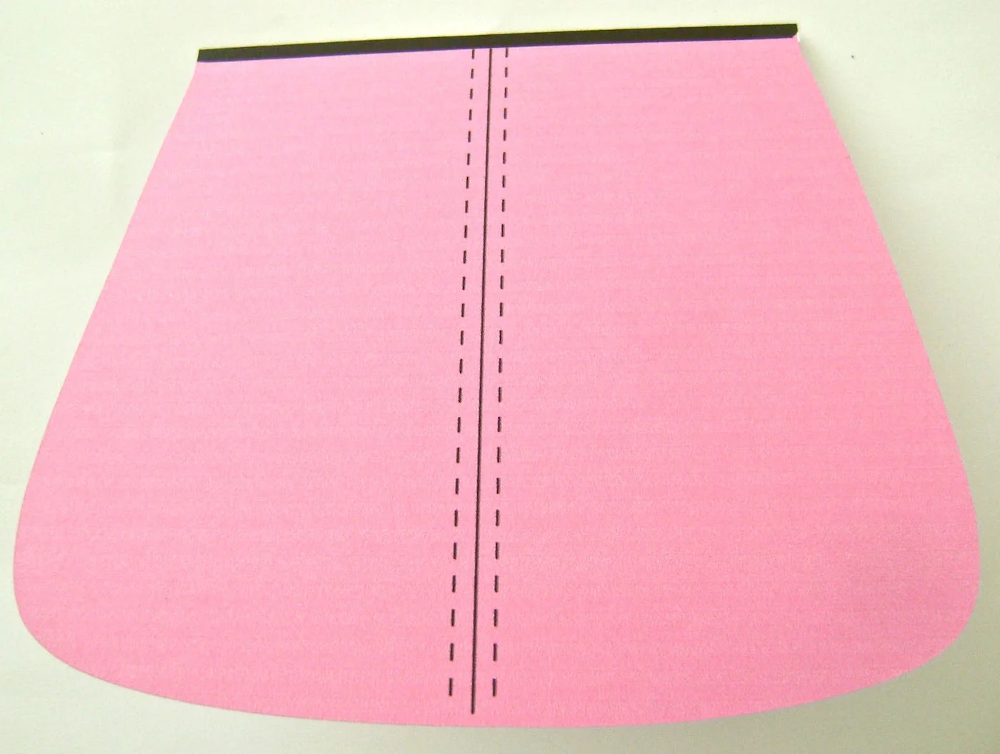 step 4 - Fold the front flap where indicated with the thick black edge resting behind the fold on the backside of the purse.