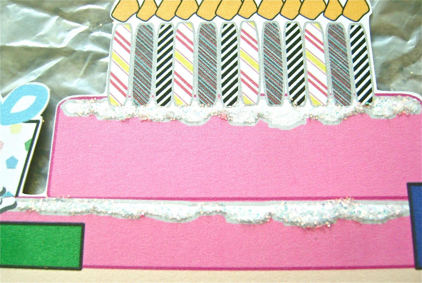 step 6 - Use a fine point glue pen to trace around and fill in the frosting on both cake layers. Sprinkle white glitter on the card and shake off excess. Allow the glue to dry.