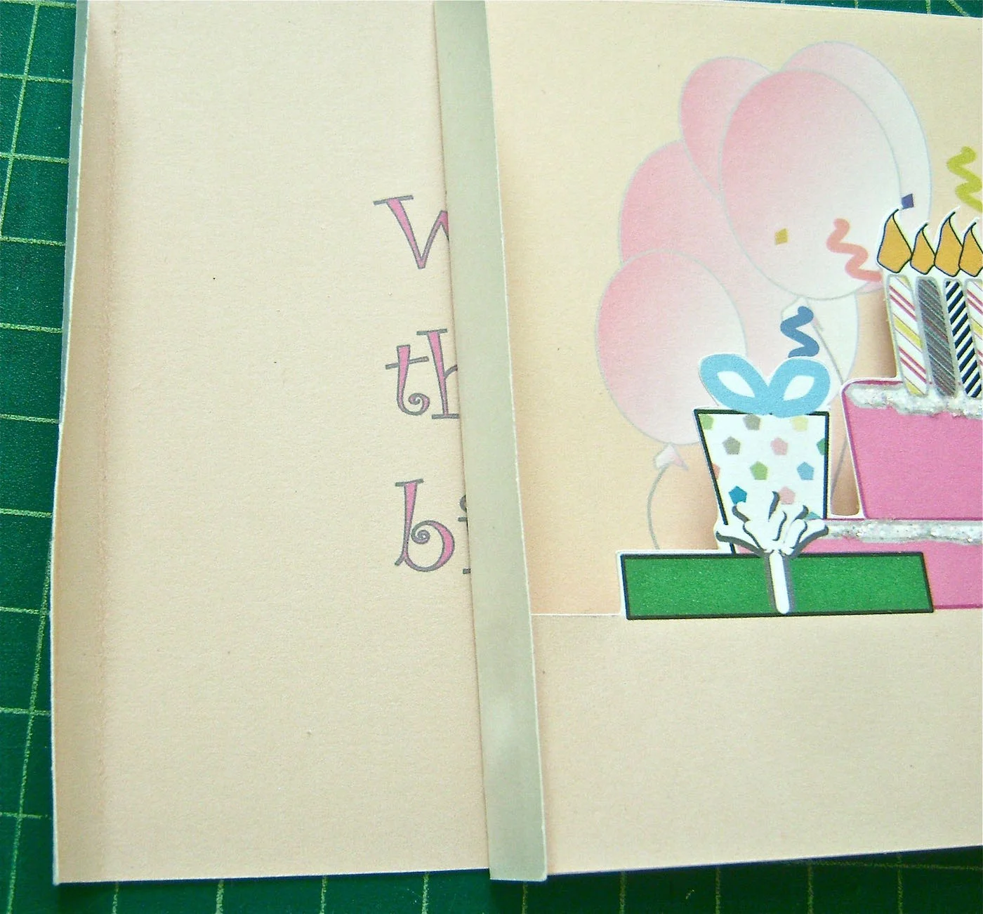 step 8 - Rub the glue stick on the blank side of the left flap of page 3. Slide the glued flap into the fold of page 4. Be sure the bottoms are aligned.
