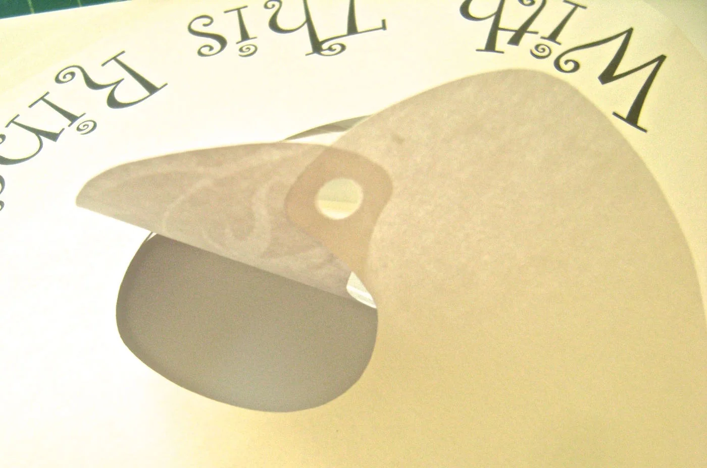 step 5 - Overlap and glue the hole in the text layer onto the non-printed side of the floral layer.