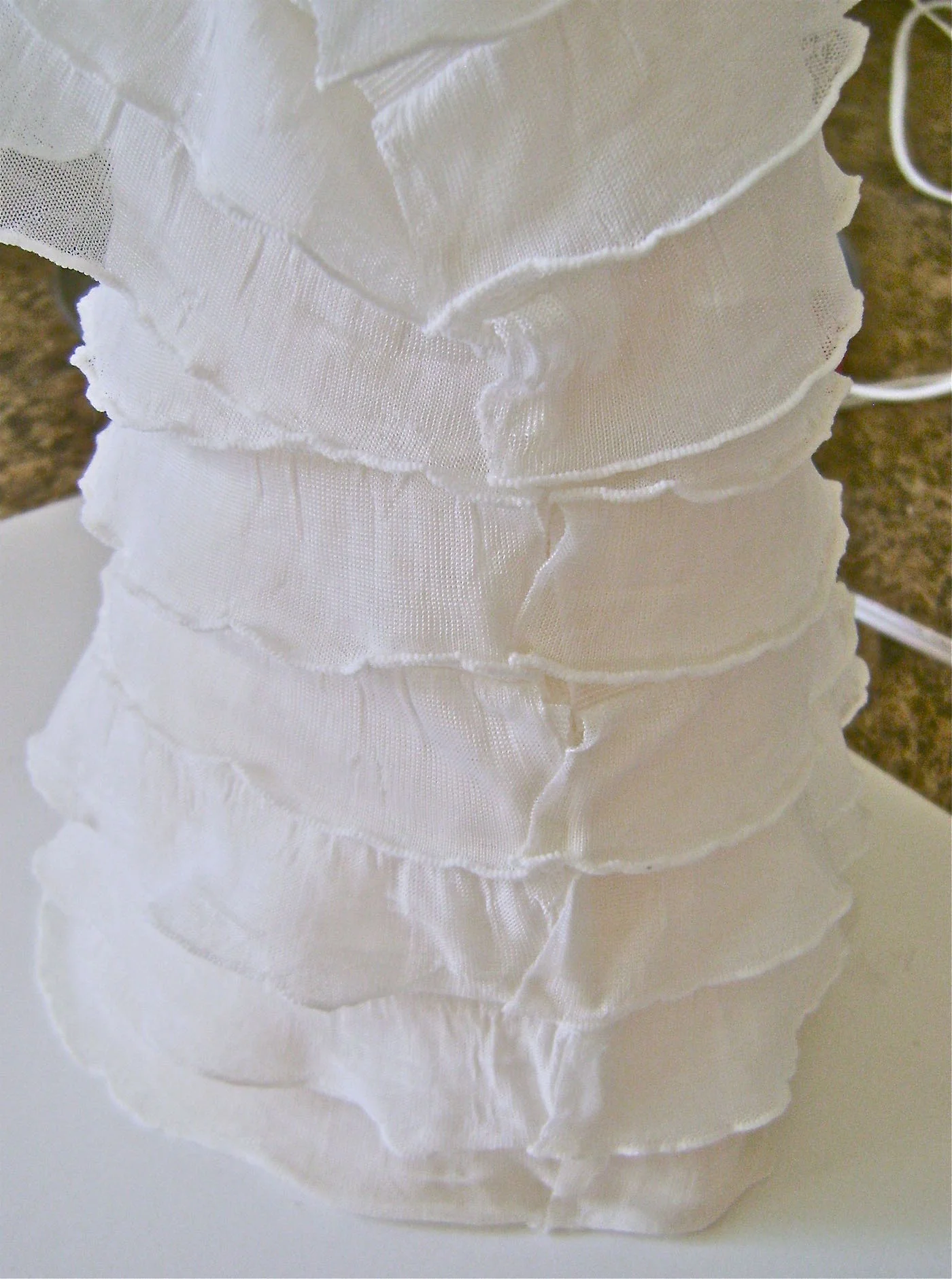 step 18 - When the seam is secure, overlap the ruffle edges and dot with glue to hold them together.