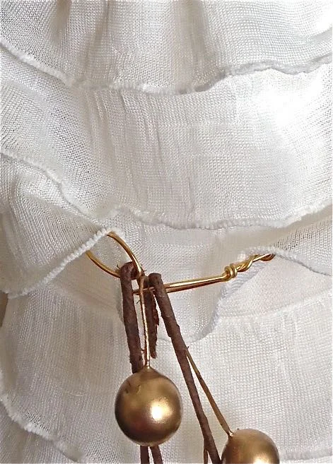 step 22 - Bend the arms at angles so the hands meet. Thread holiday stems into the hand loops and bend the stem ends to hold the hands together.