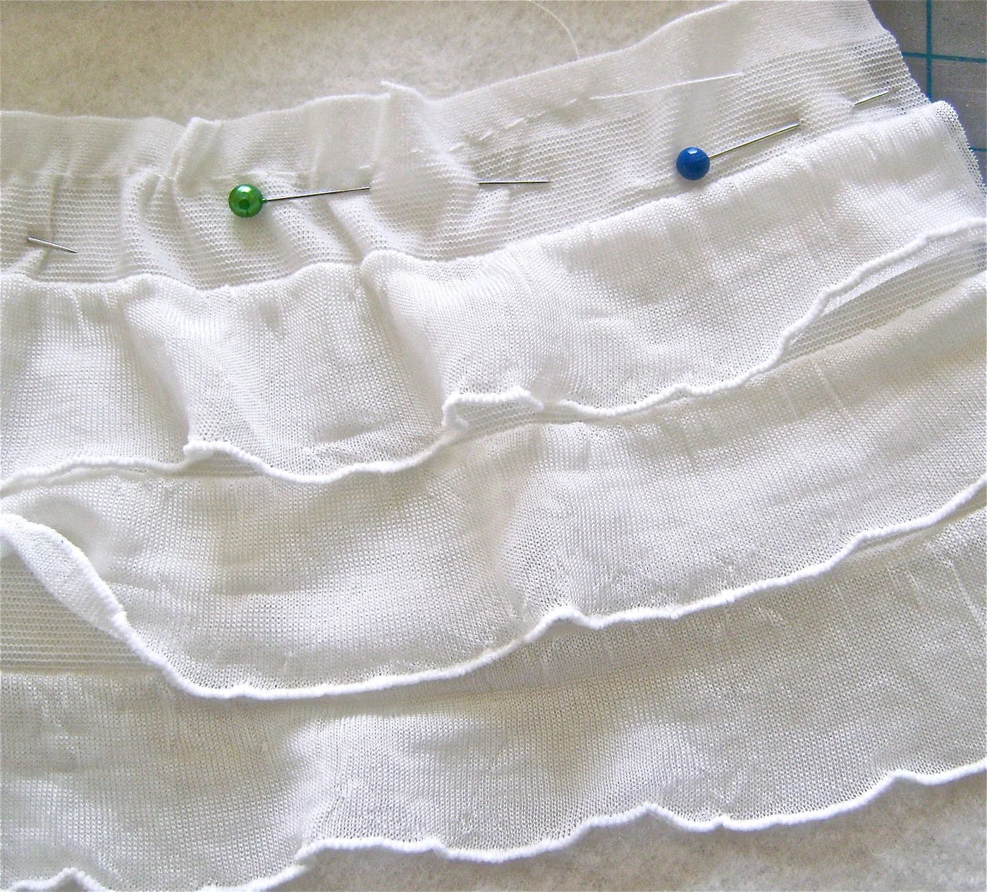 step 3 - With a basting stitch, gather the ruffles starting at 3.25” in from the end and ending at 3.25” from the other end. The purpose of gathering the strips is to ease fabric to fit the curve of the fleece.