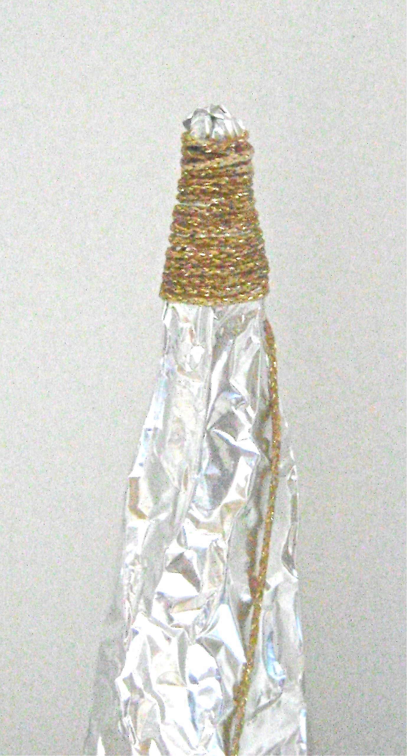 step 7 - Wear plastic gloves to wrap wet yarn around the aluminum cone. Start winding from the top to the bottom. The tree will be more interesting if there is occasional uneven spacing between the strands. 