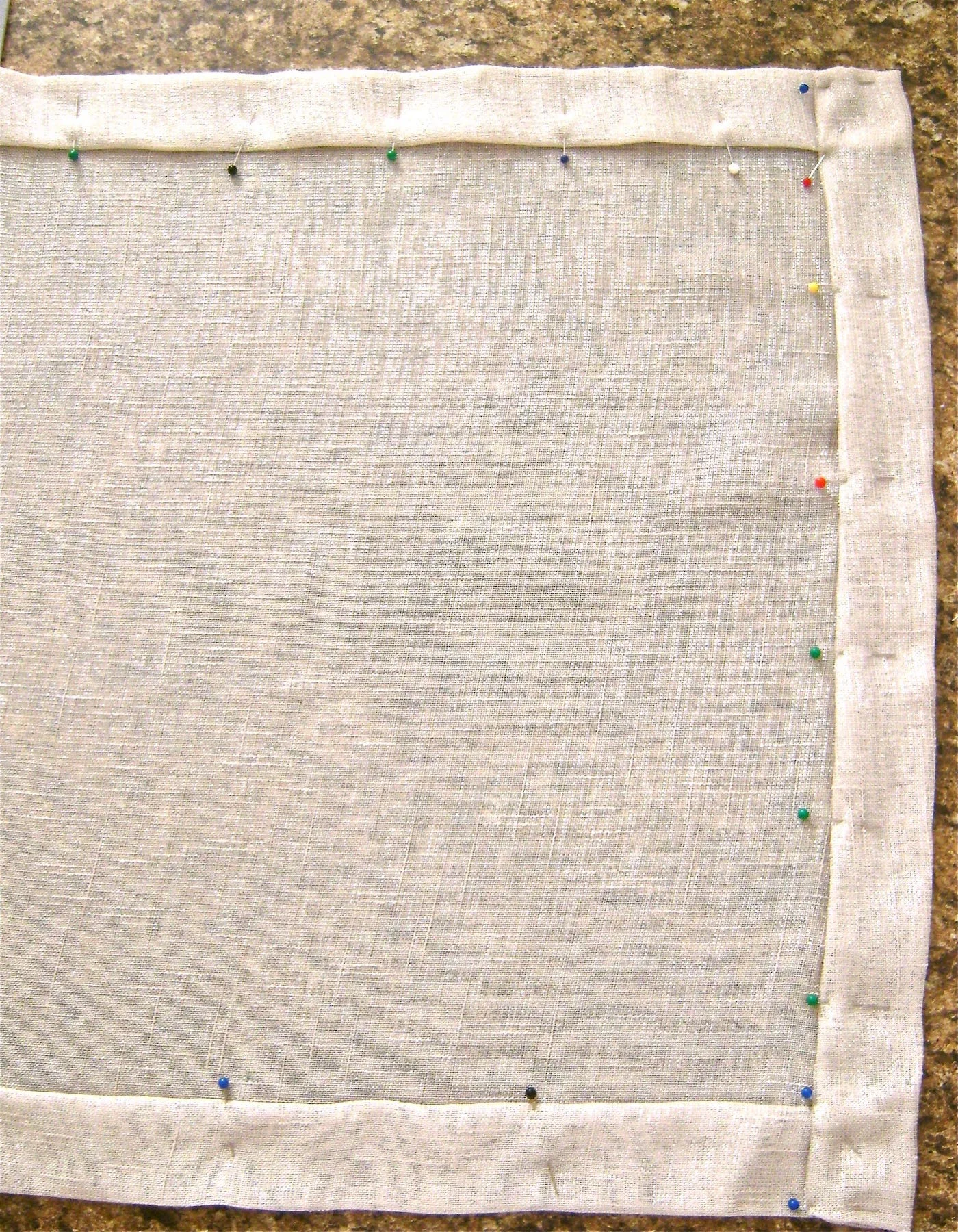 step 4 - Repeat steps #1 to #3 on the short ends of the runner. Pin all the hems to hold them in place. Sew all four of the 1.5” hems by machine.