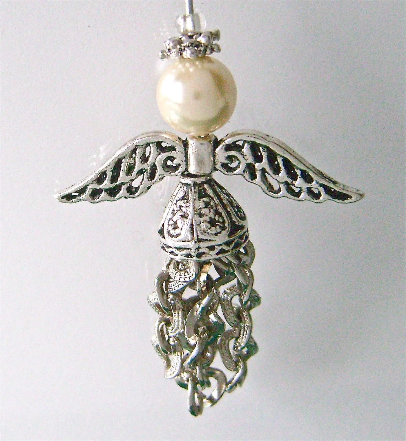 Ornament measures 3” long from the angel’s crown to the feather bottom.
