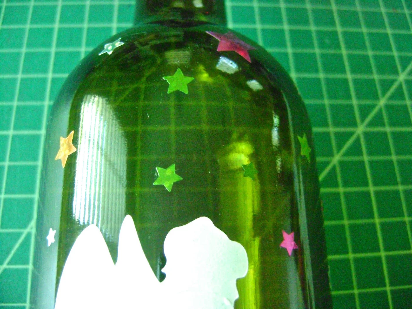 step 4 - Arrange star stickers in a variety of sizes on the bottle.
