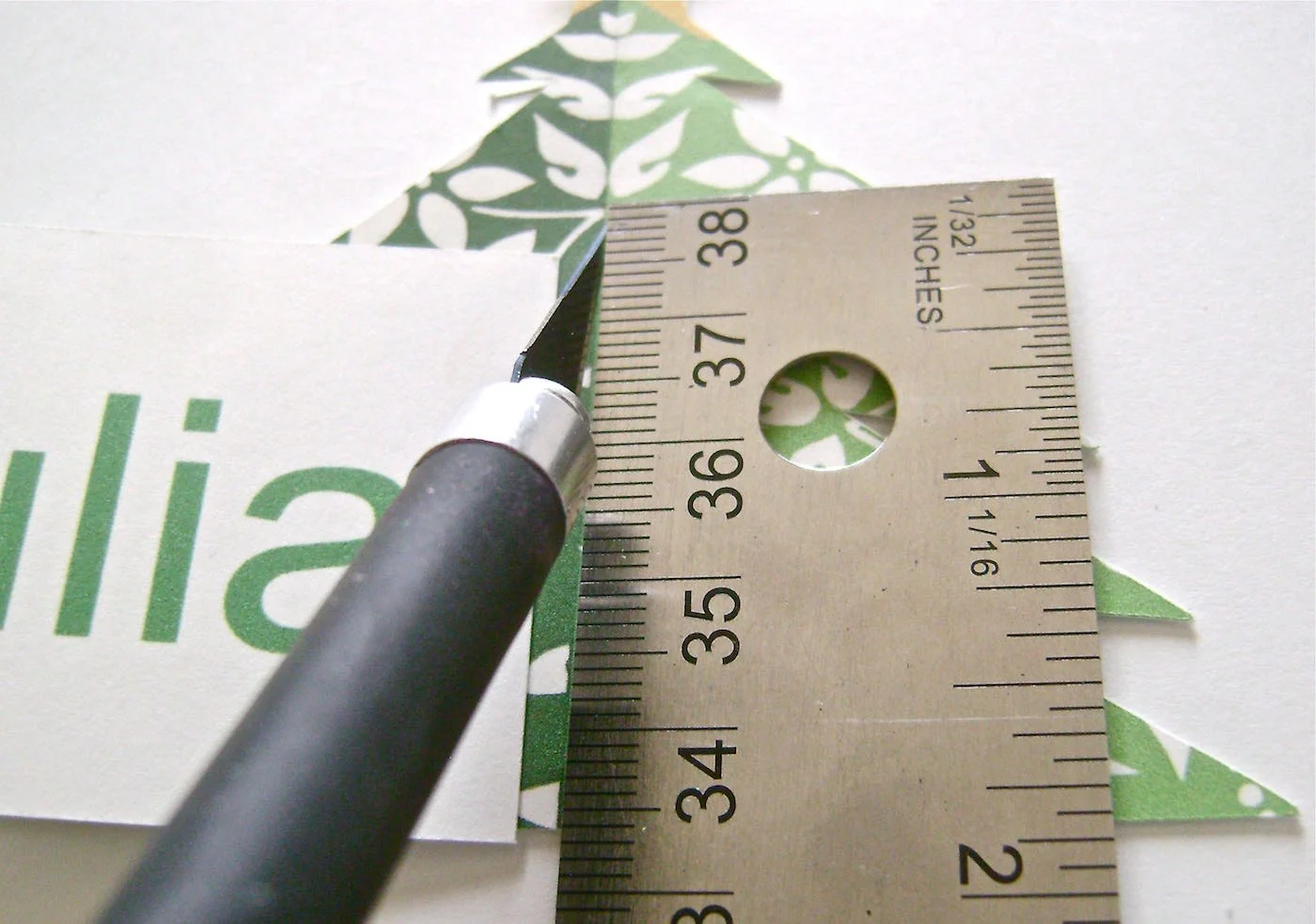 step 7 - Dinner Table Place Cards Follow the steps for free standing trees but only print out two tree images. Glue them back to back. After the glue dries, cut them out. Use a craft knife to slit the center of the tree with an opening only long enough to accommodate the height of your name card. Fold the tree in half vertically and insert the name card into the slit. The tree will help the card to stand straight.