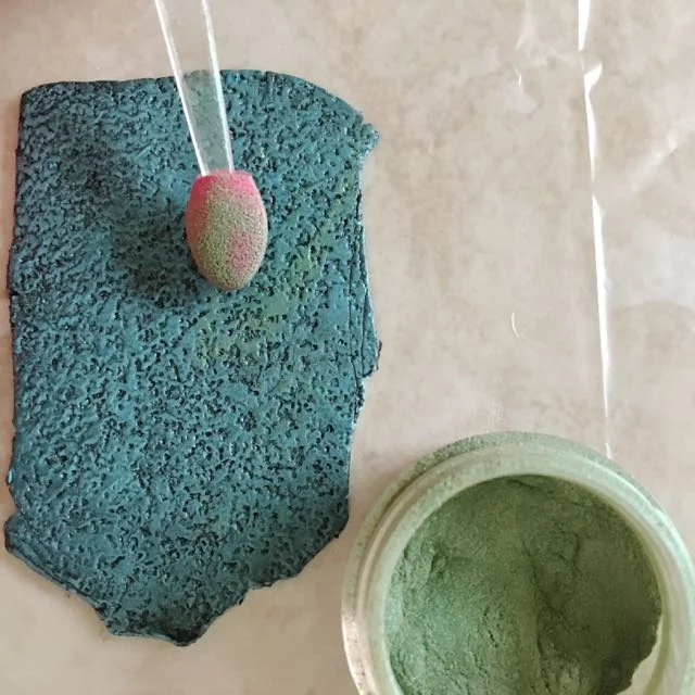 step 11 - With a soft sponge applicator or paint brush, brush green mica powder across the surface.