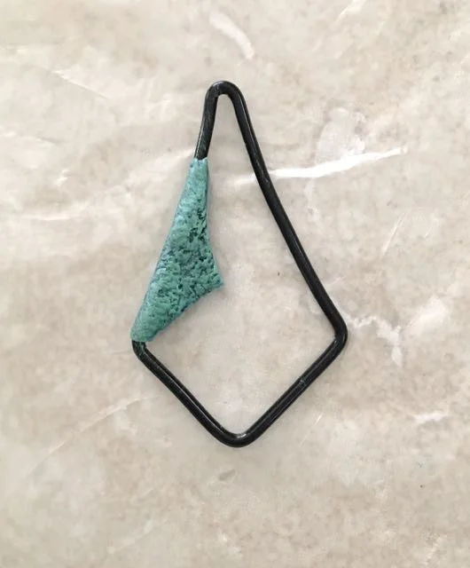 step 16 - Remove the clay and place it on the earring frame. Fold it over the wire and press the clay edges together.