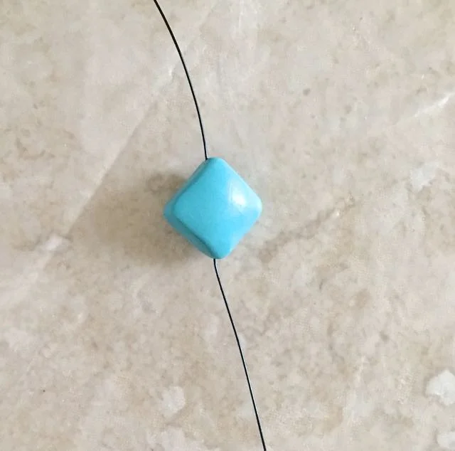 step 21 - Buff the pillow bead to a gloss. Slip a piece of 26 gauge wire through the bead.
