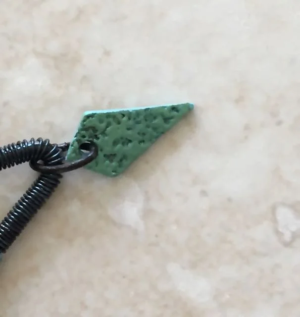 step 24 - Open and slip a 7mm jump ring into the hole in the “A” pieces and around the top center of the earring frame. Close the ring.