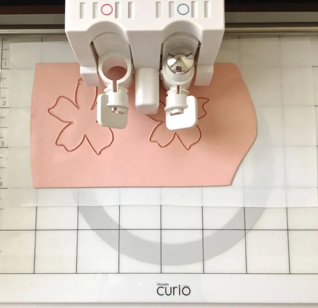 step 5 - SC – Place the clay on the shiny side of freezer paper. Press the paper to Curio’s cutting mat. Select your cut settings as follows: deep cut blade, platforms 4, speed 3, thickness 20. If you haven’t done so already, set these as your permanent “Clay” settings under "material type" as they will work for most projects. Unscrew the cap from the Deep-Cut Blade. Twist the blade to the blue #10 mark and set it into the blade holder. Send the project to Curio to cut the clay.
