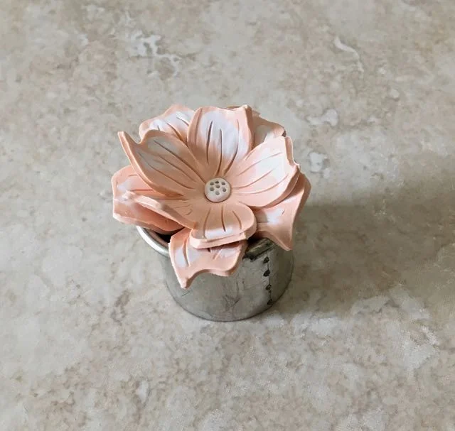 step 11 - Set the finished flower on a cookie cutter or other round ovenproof object that is slightly smaller than the flower. To give the flower dimension, gently push in on the center and bend the petal edges as desired.