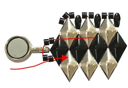 step 10 - Move the needle back in the opposite direction. Add two Delicas, the clasp, and two more Delicas. Insert the needle in the bottom hole of the BDB.