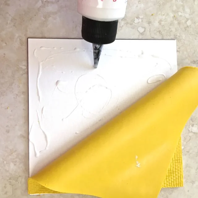 step 10 - Building The Cube – Cut a piece of mat board or other stiff material to match the size of the roof panel. Apply Liquid Polymer Clay to the piece and cover it with the matching clay panel. The smooth side should be in contact with the mat. Be skimpy with the liquid as too much will cause the pieces to slip and slide. Pierce the center of the clay and mat board for placement of the spiral wire photo holder later.