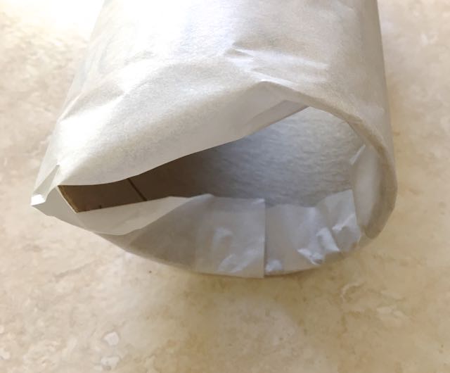step 11 - Wrap parchment paper around a 4” clean mailing tube – no sticky labels attached. Tuck the paper into the bottom of the tube to hold the parchment in place.