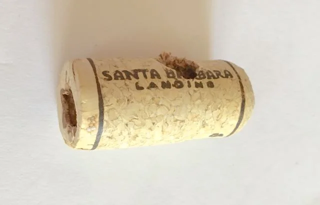 step 18 - Drill two holes in a wine cork to fit the branches. One hole should be on the very end of the cork and the other hole angled at the opposite end.