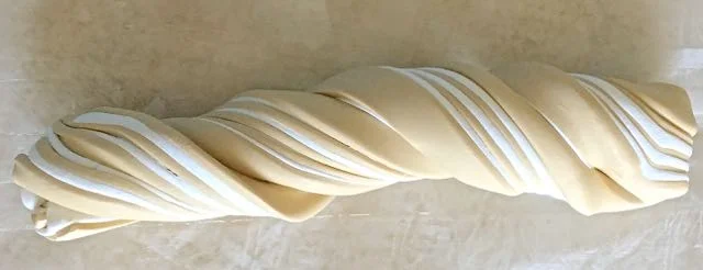 step 4 - Roll the rectangle into a tube. Twist it, fold it in half and roll it again.