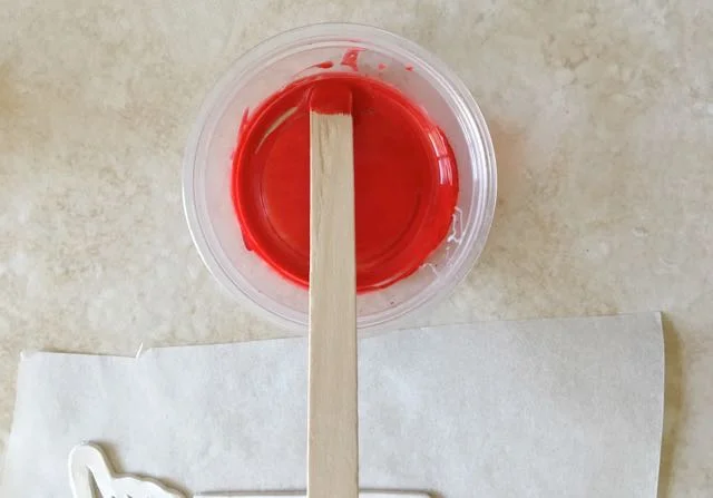 step 3 - In a small container, mix the red ink with clear liquid polymer clay using a craft stick.