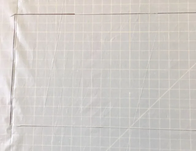 step 1 - Cover your work surface with plastic. Determine how much fabric space will be filled with color and mark off an area slightly larger than that on the plastic with a Sharpie. 