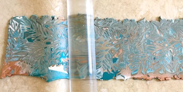 step 8 - Continue skimming until you like the surface designs and colors that are revealed. Roll across the clay to even out the thickness.