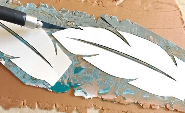 step 11 - Use a craft knife to cut out the feather shapes through both clay layers.