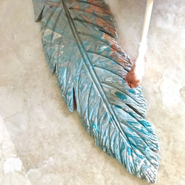 step 16 - Use a Q-tip to apply copper mica powder unevenly to the edges of the feather and the center line.