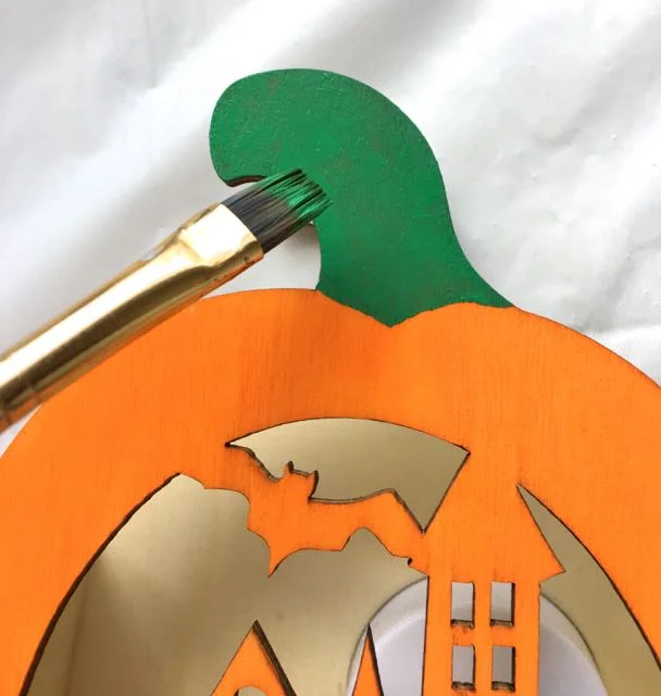 step 7 - While waiting for the paint to dry, paint the pumpkin stem Green. Paint various parts of the project between adding more silkscreen designs.