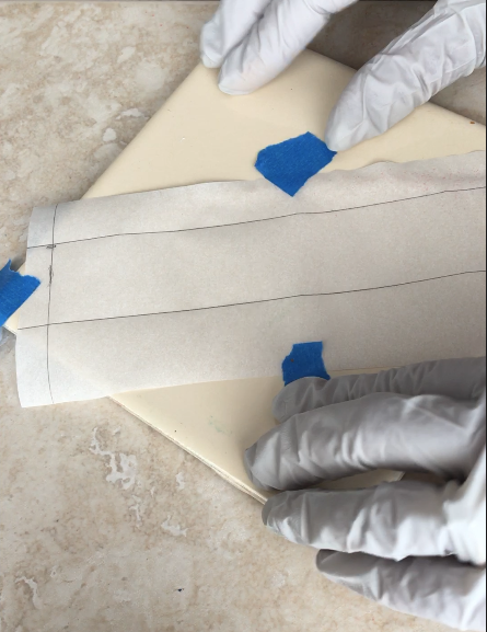 step 1 - Measure length and width of your bracelet form. The forms come in a couple of sizes. Mine was 6" x 1". Draw a rectangle on parchment paper slightly larger than your form. Tape the paper to a ceramic tile.
