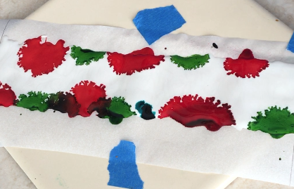 step 4 - Dot the very outside edges of the pearl liquid with Poppy Field Red, Botanical Green, and Stream Blue alcohol ink. With a light touch, pull the brush through the colors with swirling strokes. Be sure to wipe off or rinse the brush when working with different colors.