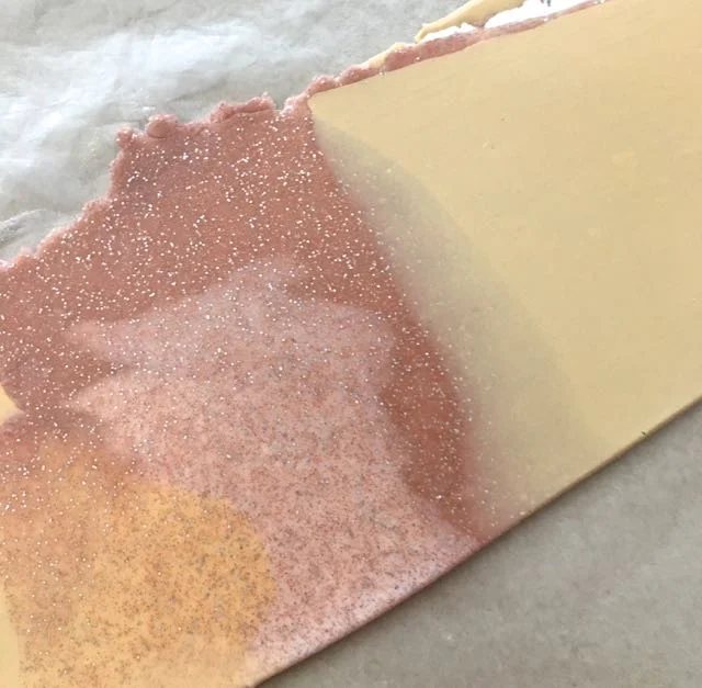 Step 10 - Roll across the clay with an acrylic roller to connect the pieces then run it through the conditioning machine on the #2 setting. Fold the clay in half vertically and put it through the machine again. Keep repeating this until you like the color blend.
