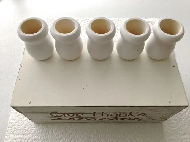 step 7 - Position the five candle cups equal distance from each other toward the back of the bin. Attach them with hot glue.