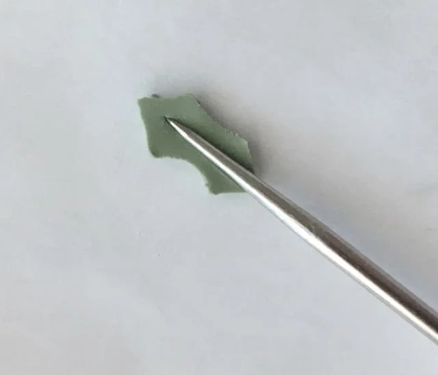 step 14 - Press the center of the leaves with a fine tool to create the center vien.