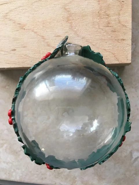 step 10 -When berries and powder have been added to all the clay strips, wrap the longest around the glass ornament