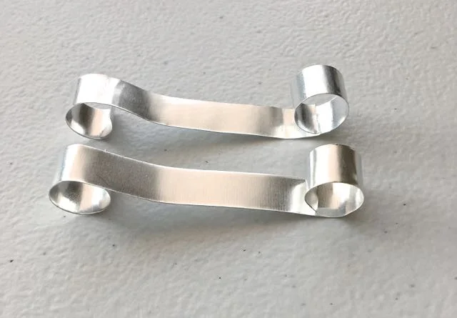 step 12 - Cut two strips of metal to measure 4.5" x .50". Curl the ends around a Sharpie.