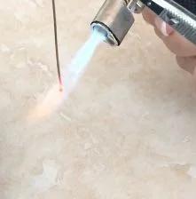 step 1 - Cut a 6” length of sterling silver wire. Grasp the wire with metal pliers, as it will become very hot. Hold the wire completely vertical. Holding it at a slight angle will cause the ball to tilt. Work over a ceramic tile with a bowl of water at the ready. Notice how the flame turns from blue to yellow. The spot where the color changes is the hottest and that's where you want to place the wire. Move the flame up and down quickly then let it settle on the end of the wire. The metal will ball in seconds.