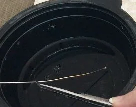 step 2 - Place the wire in the bowl of water. When it has cooled, ball the other end of the wire.