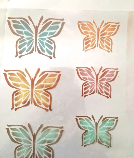 step 9 - Place the Sticker Paper on a clear transparency sheet. This material is stiffer than the Sticker Paper and will give the butterflies shape.