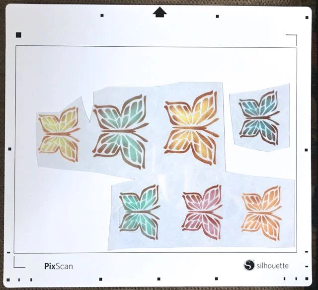 step 11 - Cutting the butterfly shapes can also be done on a Silhouette Curio or Cameo machine using a PixScan mat. Contact me if you would like more information for using Pixscan with this project.