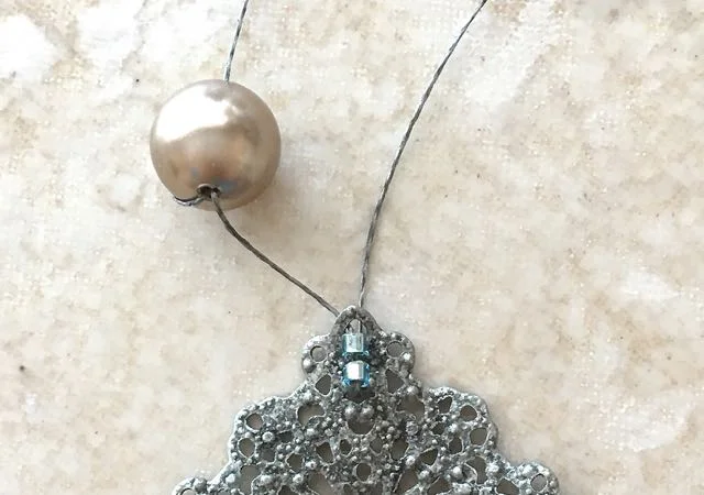step 5 - Add a seed bead. Go back through the first bead.