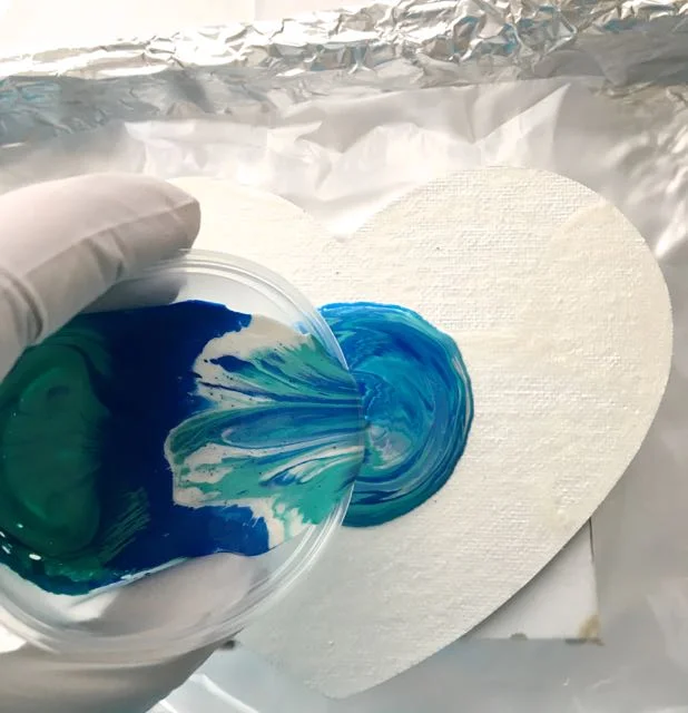 step 7 - Pour the layered colors into the center of the canvas. Pouring really is the fun part of this technique. There are many ways to add the paint to the canvas which I will describe later.