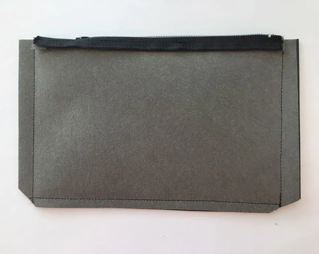step 12 - With the right sides of the pouch together, sew the sides of the pouch with a .50" seam. If the metal zipper stop is in the way, pry the curled edges open with a screw driver and remove it. Sew the bottom seam 3/8" from the edge. Trim the bottom corners at an angle.