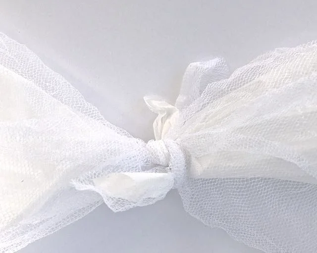 step 11 - Tie the corners (plastic and tulle layers) of each ghost to the neighboring ghost until they are all connected in a circle.