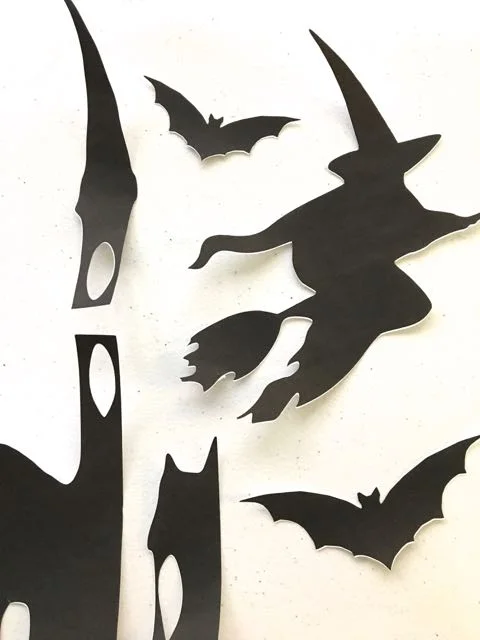 step 2 - My sidelight window measures 57” tall and 10” wide. If you have an odd size too, keep in mind you don’t need to find one single image to fit. Your art could be several images combined. I added a single creepy tree beside a haunted house image then included a separate witch and bats above it. step 3 - Print the black images to size on regular printer paper. My haunted house and tree were too tall for my printer so I printed them in sections then taped them together. You can also glue them if you allow enough overlap on the cut edges. step 4 - Cut the white plastic slightly smaller than the inside of your window frame. This will allow you to tape the plastic to the frame without any inside light showing outside. Use Scotch transparent tape. step 5 - Spray adhesive to the back of the cut images and stick them to the plastic panel. You can alternately tape the images to the plastic. The tape may be more noticeable.