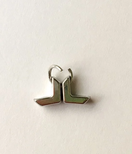 step 1 - Using jewelry pliers, open a jump ring. Insert each end into the holes in two chevron beads. The beads should be positioned as shown.