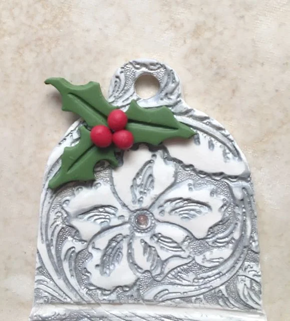 step 14 - Lightly press the berries to the leaves. If your embossed design has a center point, press on an appropriate size hot fix rhinestone.