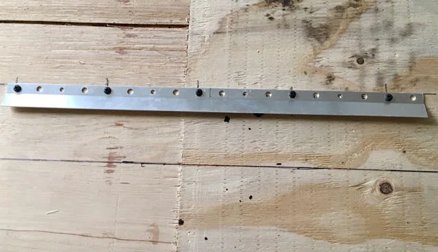 step 20 - The Hardware - Turn the headboard wrong side up. Use the horizontal line to determine where to attach one piece of the hanger system. Follow the package instructions. The system comes with two different length screws. Use the shorter ones on the plywood.