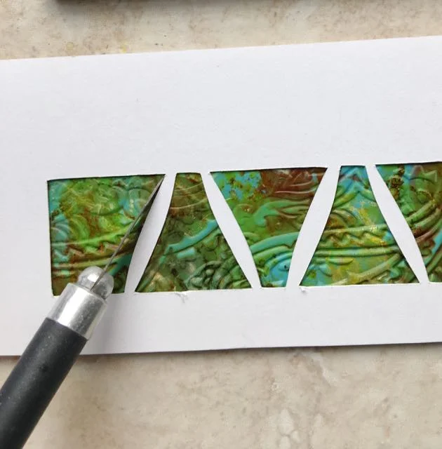 step 8 - Use the stencil to cut out beads from the embossed clay strip.